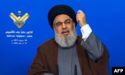 FILE - The leader of the Lebanese Shiite party, Hassan Nasrallah, delivers a televised speech from an undisclosed location, in this image grab taken from Hezbollah's al-Manar TV on June 8, 2021.