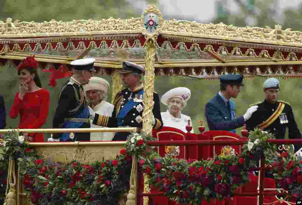 Britain's Royal Family from left, Kate, Duchess of Cambridge, Prince Philip Camilla, Duchess of Cornwall, Prince Charles, Queen Elizabeth, Prince William and Prince Harry on the royal barge.