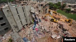 FILE - A view of rescue workers attempting to find survivors from the rubble of the collapsed Rana Plaza building in Savar April 30, 2013.