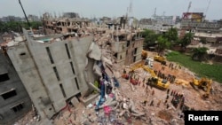 FILE - A view of rescue workers attempting to find survivors from the rubble of the collapsed Rana Plaza building in Savar April 30, 2013.