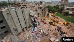 FILE - A view of rescue workers attempting to find survivors from the rubble of the collapsed Rana Plaza building in Savar April 30, 2013.