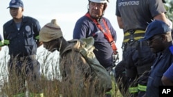 An illegal miner is rescued from a sealed-off gold mine shaft near Johannesburg Feb. 16, 2014.