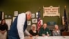 A resident of Dixville Notch check in to cast their ballots in the US election at midnight in the living room of the Tillotson House at the Balsams Grand Resort, marking the first votes in the US election, in Dixville Notch, New Hampshire, Nov. 5, 2024.