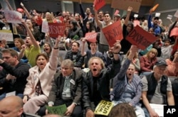 People shout during Republican U.S. Rep. Chris Stewart town hall meeting, March 31, 2017, in Salt Lake City.