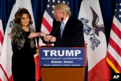 Former Alaska Gov. Sarah Palin, left, endorses Republican presidential candidate Donald Trump during a rally at the Iowa State University in Ames, Iowa, Jan. 19, 2016.