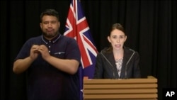 In this image made from video, New Zealand's Prime Minister Jacinda Ardern, right, speaks during a press conference in Wellington, Thursday, March 21, 2019.