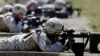 FILE - Female soldiers from 1st Brigade Combat Team, 101st Airborne Division train on a firing range while testing new body armor in Fort Campbell, Ky., in preparation for their deployment to Afghanistan.