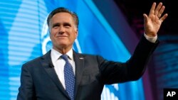 FILE - Former Republican presidential candidate Mitt Romney waves after speaking about the tech sector during an industry conference in Salt Lake City, Jan. 19, 2018.