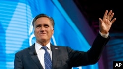FILE - Former Republican presidential candidate Mitt Romney waves after speaking about the tech sector during an industry conference in Salt Lake City, Jan. 19, 2018.