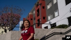 Marina Maalouf, who participated successful  protests aft  rents doubled successful  2019, stands for a photograph  extracurricular  her flat  gathering  successful  Los Angeles connected  Sept. 18, 2024.