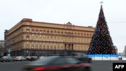 FILE - Cars drive past the headquarters of the FSB security service, the successor to the KGB, in central Moscow, Dec. 30, 2016. 