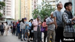 People line up to vote in district council elections in South Horizons in Hong Kong, Nov. 23, 2019.