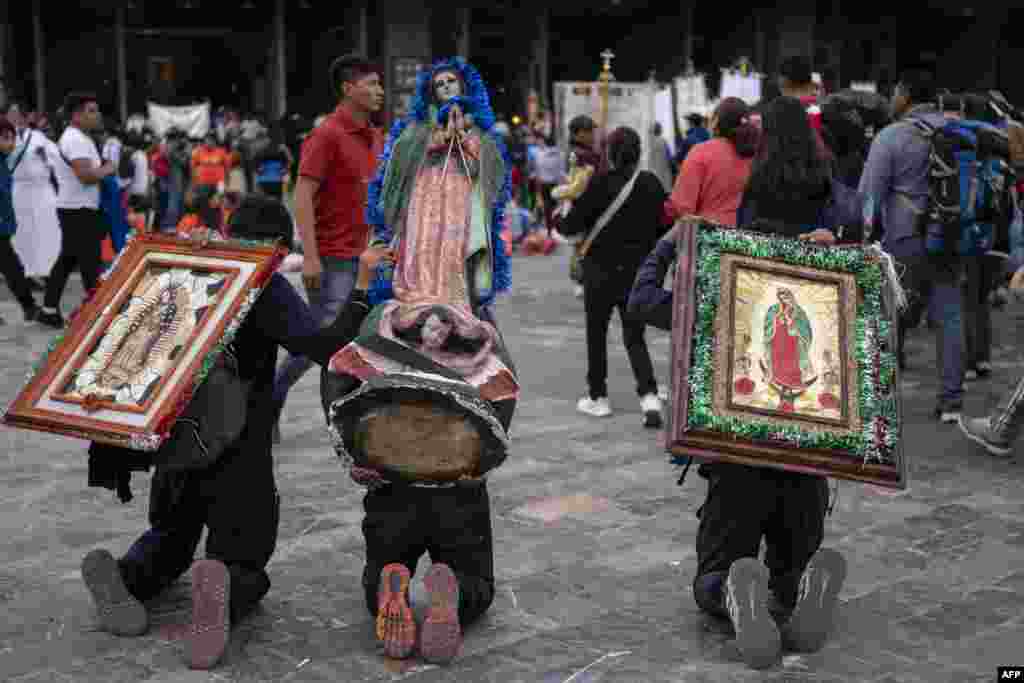 Catholic penitents carrying images of the Virgin of Guadalupe advance on their knees to participate in the commemoration of the Virgin's day at the Basilica of Guadalupe in Mexico City, Dec. 10, 2024. 