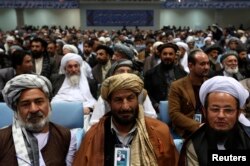 FILE - Members of the Loya Jirga, or grand council, attend during the last day of the session, in Kabul, Nov. 24, 2013.