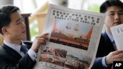 북한 주민이 8일 제7차 당대회 기사가 실린 노동신문을 읽고 있다