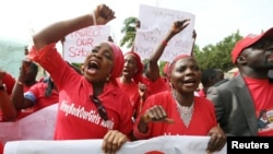 Nigerians take part in a protest demanding for the release of secondary school girls abducted from the remote village of Chibok, in Asokoro district in Abuja, Nigeria, May 13, 2014. 