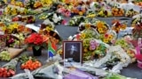 Flowers left by mourners surround a portrait of Nelson Mandela in the Sandton district of Johannesburg. Mandela, the revered icon of the anti-apartheid struggle in South Africa and one of the towering political figures of the 20th century, has died on Dec