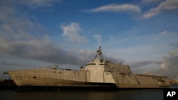FILE - This Nov. 30, 2016, file photo shows the USS Gabrielle Giffords, a Naval littoral combat ship built at the Austal USA shipyards, docked on the Mobile River in Mobile, Ala.