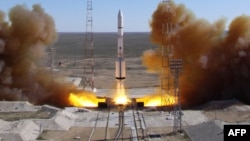 FILE - A Russian-built Proton rocket with Russian relay satellite Luch-5V and the Kazakh communication satellite KazSat-3 aboard blasts of from a launch pad in the Russian-leased Kazakhstan's Baikonur cosmodrome, April 28, 2014.