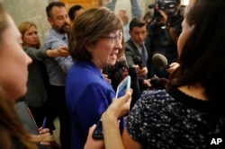 Sen. Susan Collins, R-Maine, speaks to members of the media outside her office on Capitol Hill in Washington, Sept. 17, 2018.