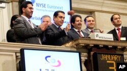 FILE - Ambassador Ali Bin Fahad Al Hajri (center) Qatari Ambassador to the U.S., rings the New York Stock Exchange closing bell, as Qatari Ambassador to the U.N. Nassir Abdulaziz Al-Nasser, gavels the market closed, Jan. 3, 2011. At left is Saif al-Mansoori, deputy CEO, Qatar Exchange. 