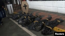 Dummies simulating corpses and a cardboard coffin are seen at the gates of the Venezuelan National Guard headquarters during a protest by opposition lawmakers in Caracas, Venezuela, June 20, 2017. 