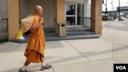 Buddhist monk Sutham Nateetong walks in front of Union Medical Center, in Chicago. June 3, 2019