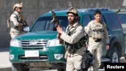 FILE - Afghan security forces arrive at the site of a showdown between Taliban and Afghan forces in Kabul, Afghanistan, March 1, 2017. 