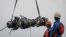Rescue team members stand during lifting-up an turbine engine of Lion Air flight JT610 at the north coats of Karawang, Indonesia, Nov. 3, 2018. 