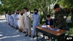 Miembros de las Fuerzas Armadas afganas registran los nombres de un grupo talibán de presos antes de ser puestos en libertad, el 26 de mayo.