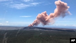 In this photo provided by the U.S. Geological Survey, red ash rises from the Puu Oo vent on Hawaii's Kilauea Volcano after a magnitude-5.0 earthquake struck the Big Island, Thursday, May 3, 2018 in Hawaii Volcanoes National Park.