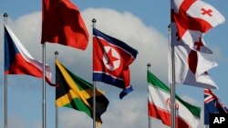 The North Korean flag, center, flies amongst flags from many nations as they fly at the Olympic Village at the 2018 Winter Olympics in Gangneung, South Korea, Thursday, Feb. 1, 2018.