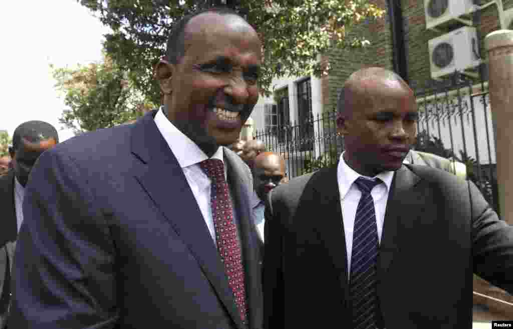 Kenya's National Assembly majority leader Aden Duale, left, is escorted out of Parliament in Kenya's capital Nairobi, Dec. 18, 2014.