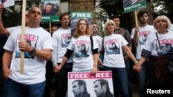 Family and friends of Greenpeace activist Kieron Bryan who is detained in Russia, protest outside the Russian Embassy in London, Oct. 5, 2013.