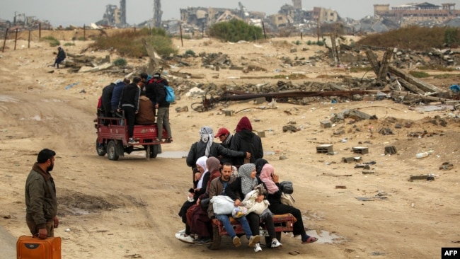 People ride in the back of a tricycle transporting them from Nuseirat to Gaza City on Feb. 10, 2025 as displaced people return home amid the current ceasefire deal in the war between Israel and Hamas.