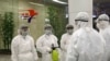 State Commission of Quality Management staff in protective gear and disinfectant prepare to check the health of travelers arriving from abroad at the Pyongyang Airport in Pyongyang, North Korea, Feb., 1, 2020.