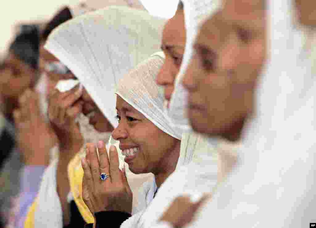 Women cry during a funeral service for 24 migrants drowned while trying to reach the Southern coasts of Italy in Msida, in the outskirts of Valletta, Malta.