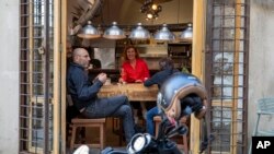 Customers have a drink at a restaurant in Beirut, Lebanon, May 4, 2020 when government allowed barber shops, car showrooms and restaurants to open at 30% capacity during the day.