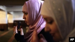 Young women pray in the Heart of Chechnya mosque during Friday Prayer