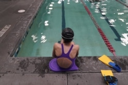 A proposed ban on transgender athletes playing female school sports in Utah would affect transgender girls like this 12-year-old swimmer seen at a pool in Utah on Monday, Feb. 22, 2021. She and her family spoke with The Associated Press on the condition o