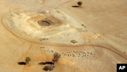 FILE- In this July 13, 2002, parched land is seen near a dry reservoir northwest of Sydney, Australia.