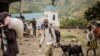 Displaced persons coming from the Sake area, 25km North-West of Goma, carry their belonging as they arrive in Mugunga, 10km north-west of Goma, on January 23, 2025.