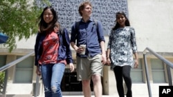 University of California students, from left, Alice Ma,Tyler Heintz and Anjali Banerjee walk near the university's campus, June 6, 2018, in, Berkeley, Calif. The students, who were in Nice, France, when a terrorist drove a truck down a promenade killing 83 people, including one of their classmates, have channeled their grief and anger into two nonprofits to fight terrorism. 