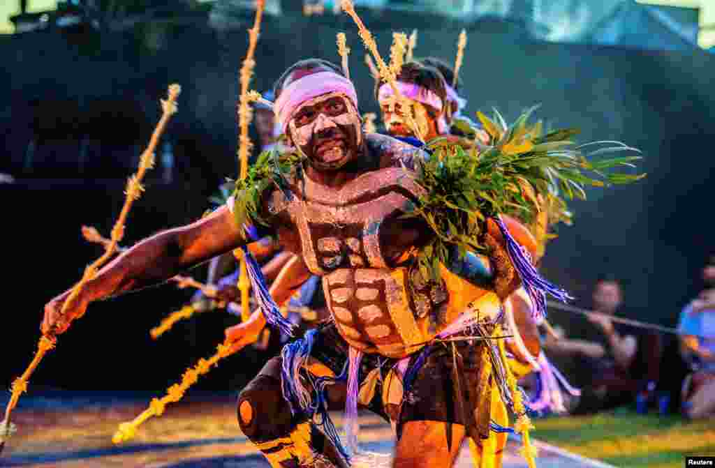 Spectators watch Aboriginal dancers and acrobats perform with a 50-tonne Arcadia spider, constructed from used repurposed military hardware, during a laser and pyrotechnics show in Perth, Australia.