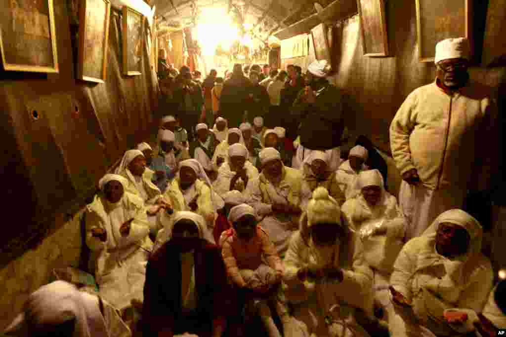 Christian worshippers from Nigeria pray at the Church of Nativity in the West Bank town of Bethlehem on Christmas Eve, Dec. 24, 2013. 