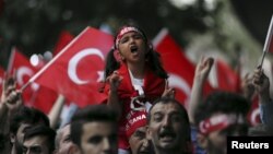 On the same day as a PKK bombing in Igdir province, supporters of ultranationalist groups march with Turkish national flags during a protest against Kurdish militant attacks on Turkish security forces, in Istanbul, Sept. 8, 2015.