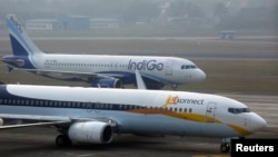 An IndiGo Airlines aircraft and JetKonnect Boeing 737 aircraft taxi at Mumbai's Chhatrapathi Shivaji International Airport on February 3, 2013.