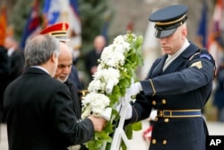 Afghan leaders Abdullah Abdullah, left, and Ashraf Ghani lay a wreath at the Tomb of the Unknowns at Arlington National Cemetery in Arlington, Va., March 24, 2015.