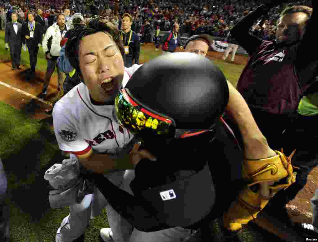 Oct 30, 2013; Boston, MA, USA; Boston Red Sox relief pitcher Koji Uehara (left) celebrates with designated hitter David Ortiz (right) after game six of the MLB baseball World Series against the St. Louis Cardinals at Fenway Park. The Red Sox won 6-1 to wi