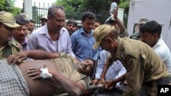 An Indian Border Security Force soldier injured in exchange of fire on the India Pakistan border is brought for treatment at the government medical college hospital in Jammu, India, July 15, 2015. 